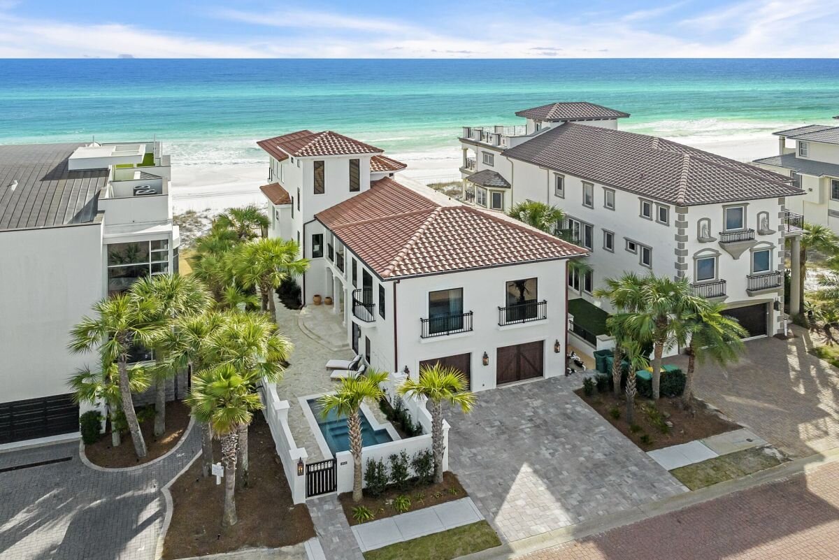 Aerial view of Villa Mareblu and neighboring Gulf-front homes with the Gulf behind them